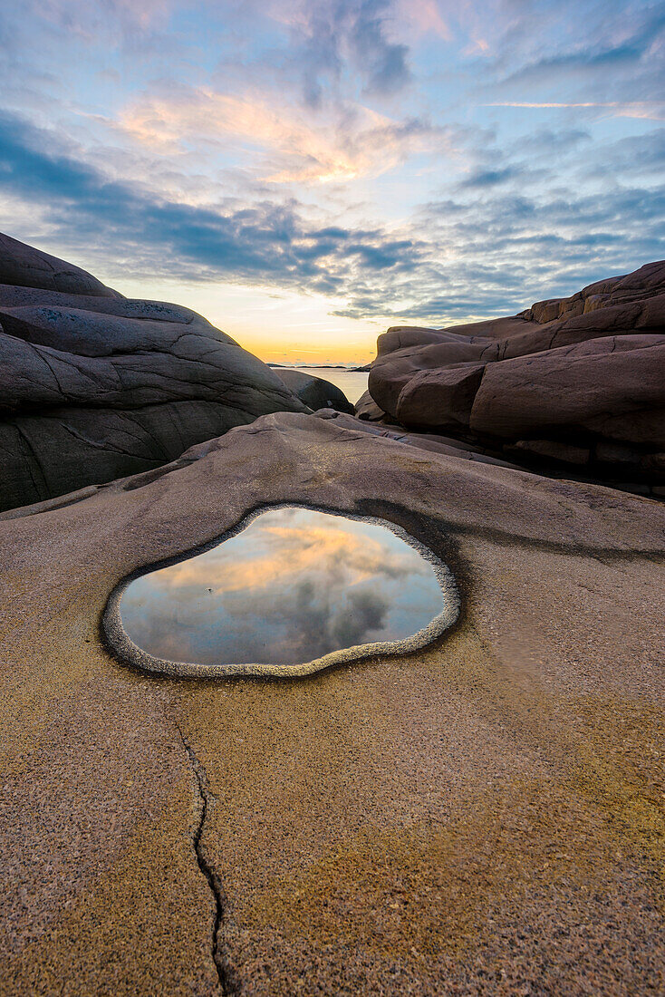 Evening sky reflecting in rock pool