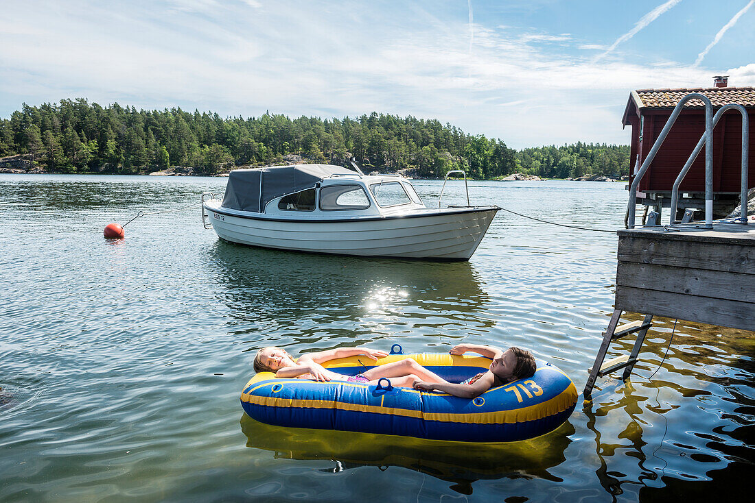 Girls relaxing in inflatable boat