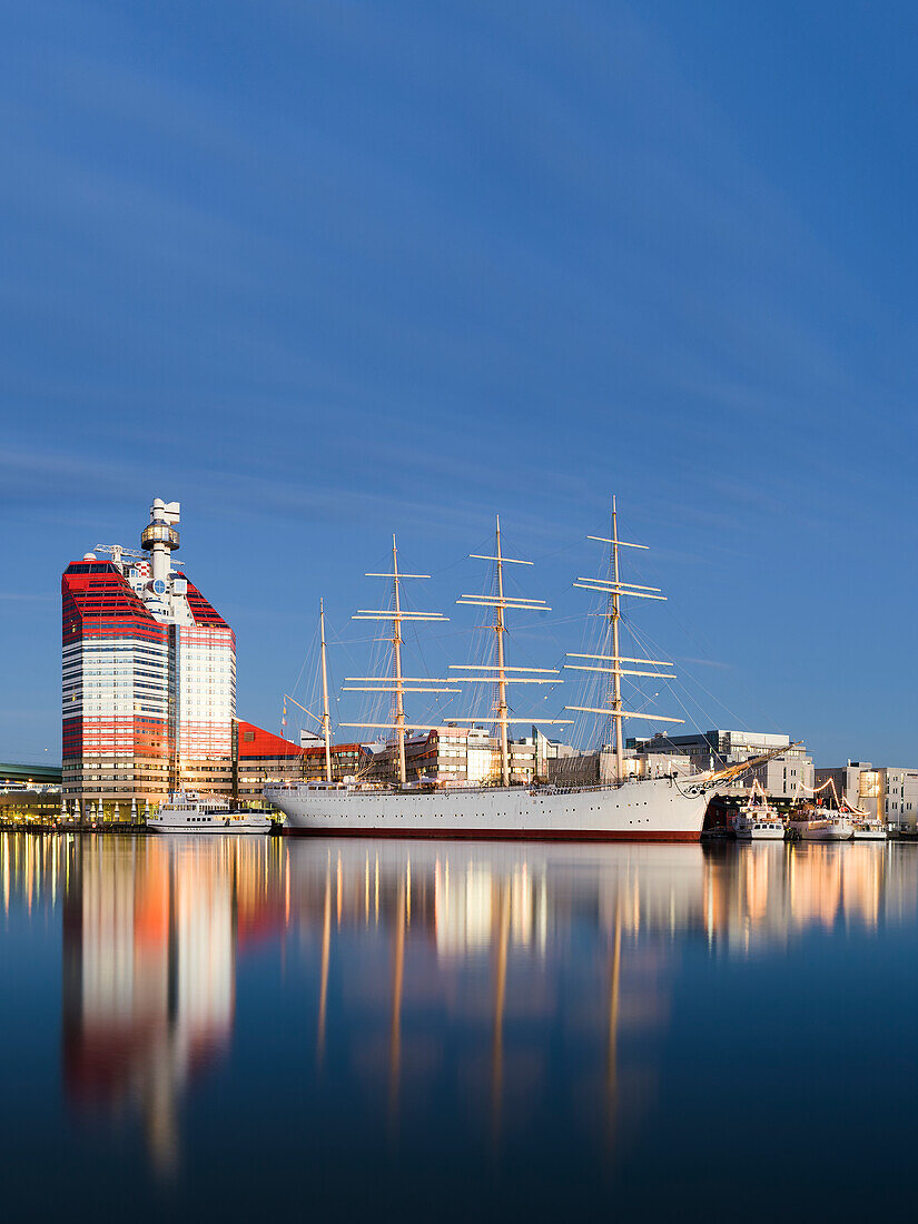 Moored tall ship reflecting in water