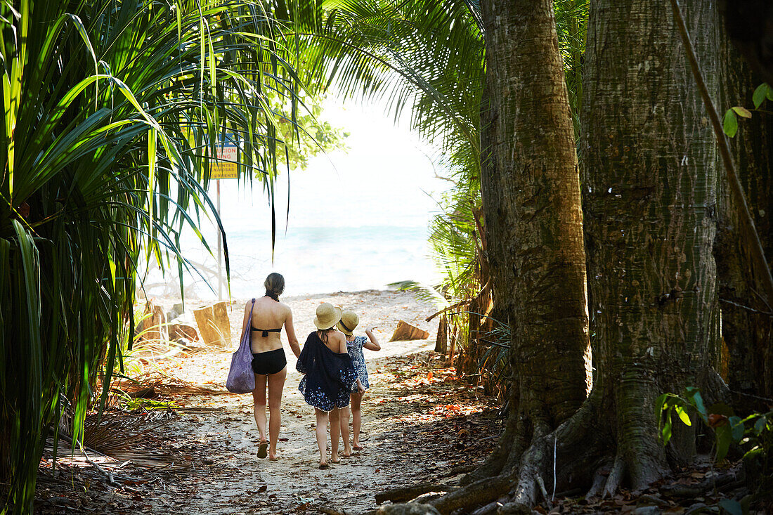 Mother with daughters walking at beach