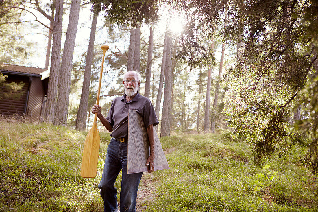 Senior man holding oar