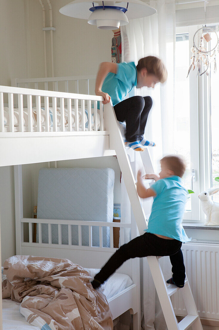 Boys playing on bunk bed