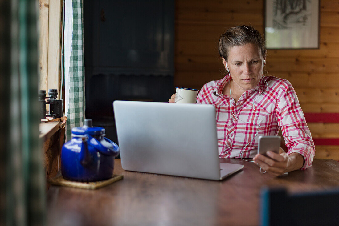 Woman at home using laptop