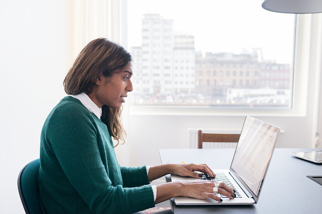 Woman working on laptop in office