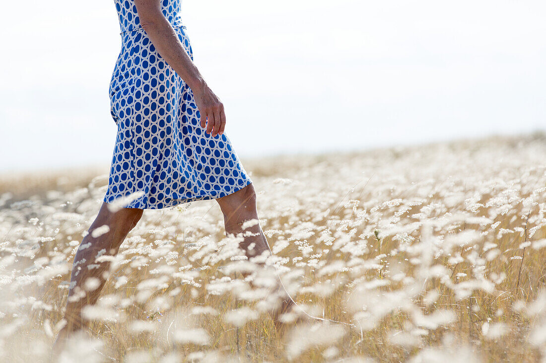 Woman walking through meadow