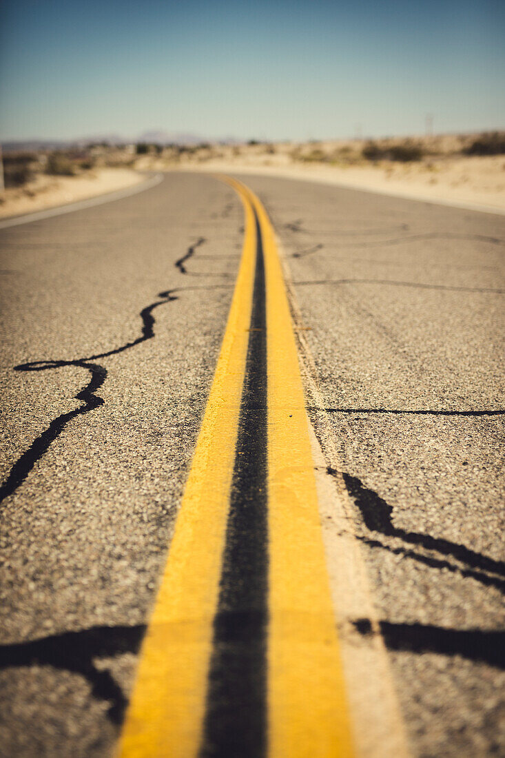Road marks on empty road in desert