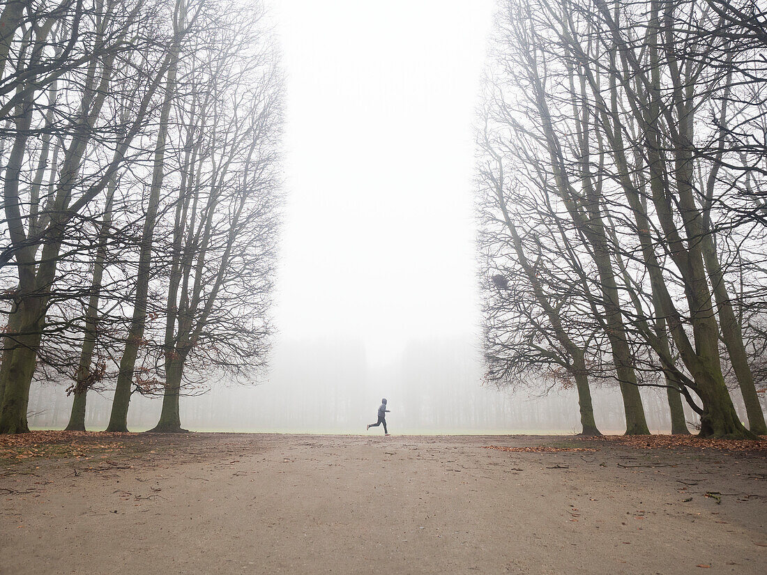 Person läuft im nebligen Park