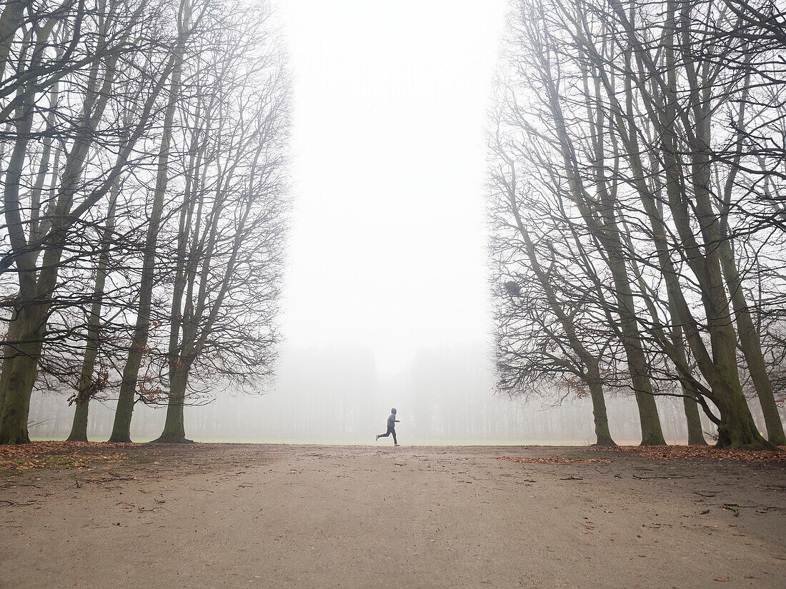 Person running in foggy park