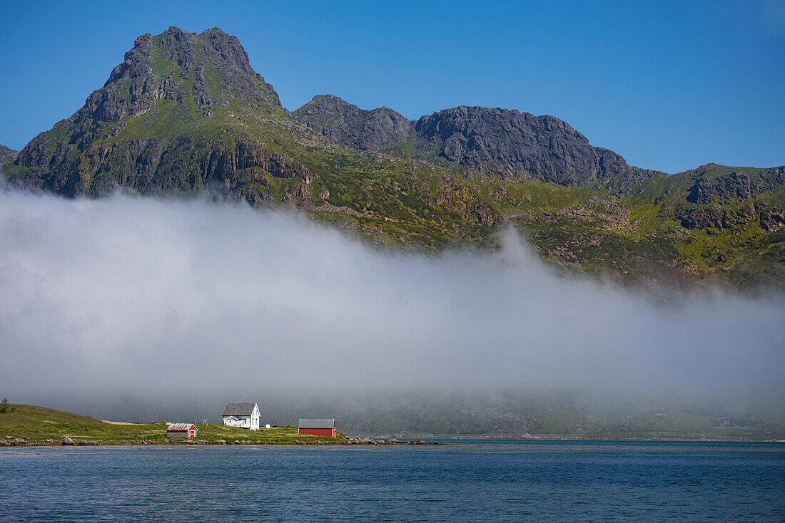 Clouds covering small village on sea coast