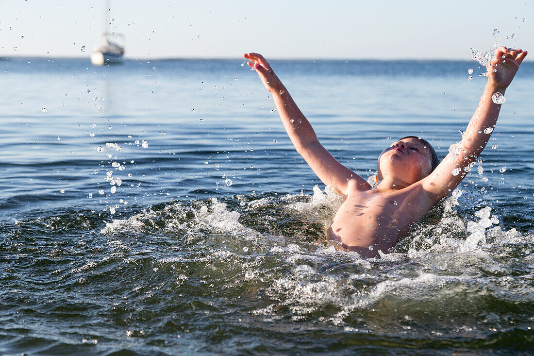 Boy splashing in lake