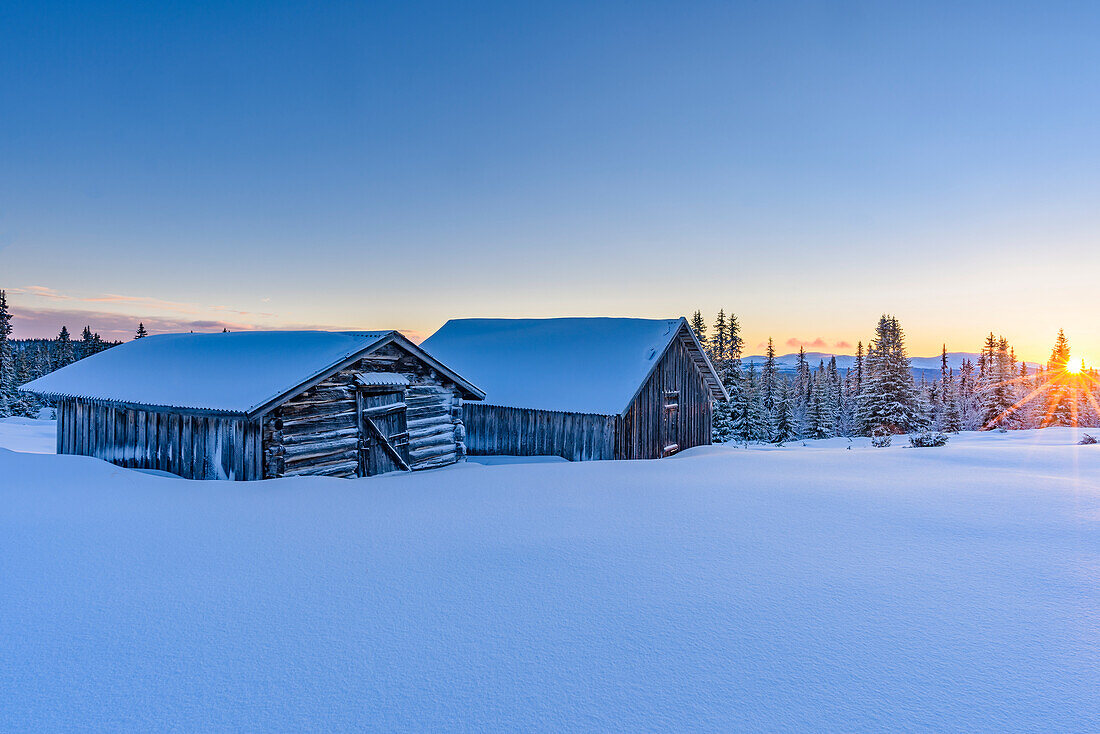 Wooden barn in winter landscape