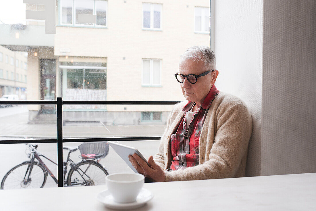 Senior man using digital tablet