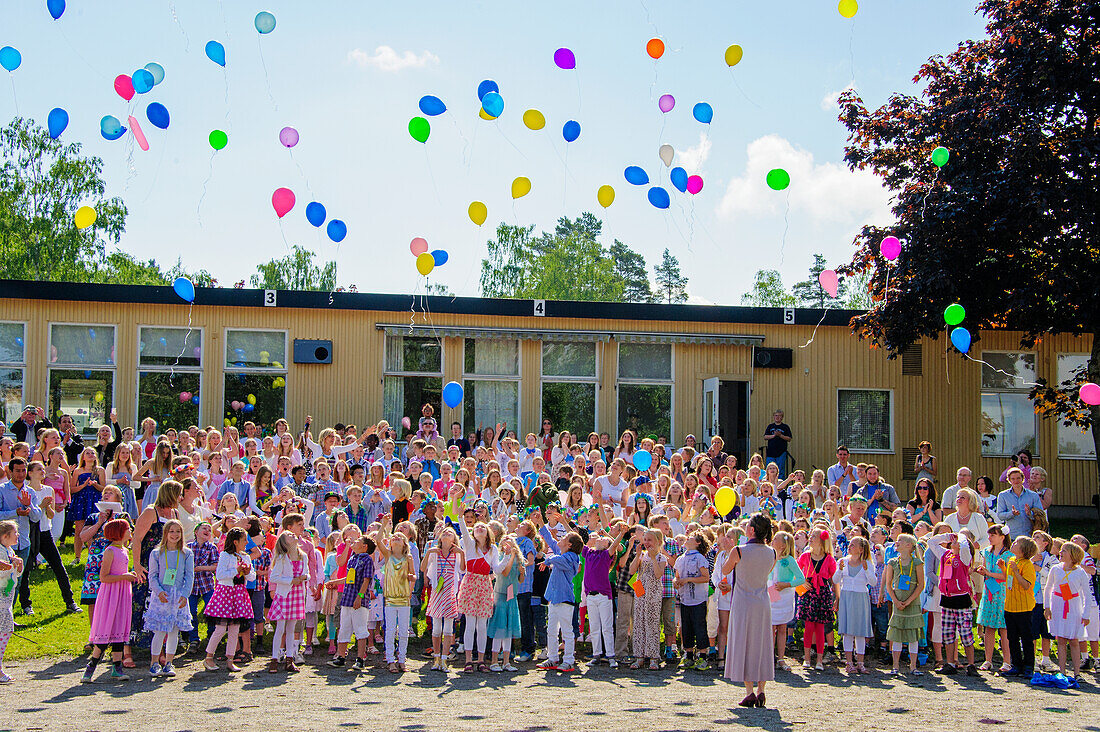 Children releasing balloons