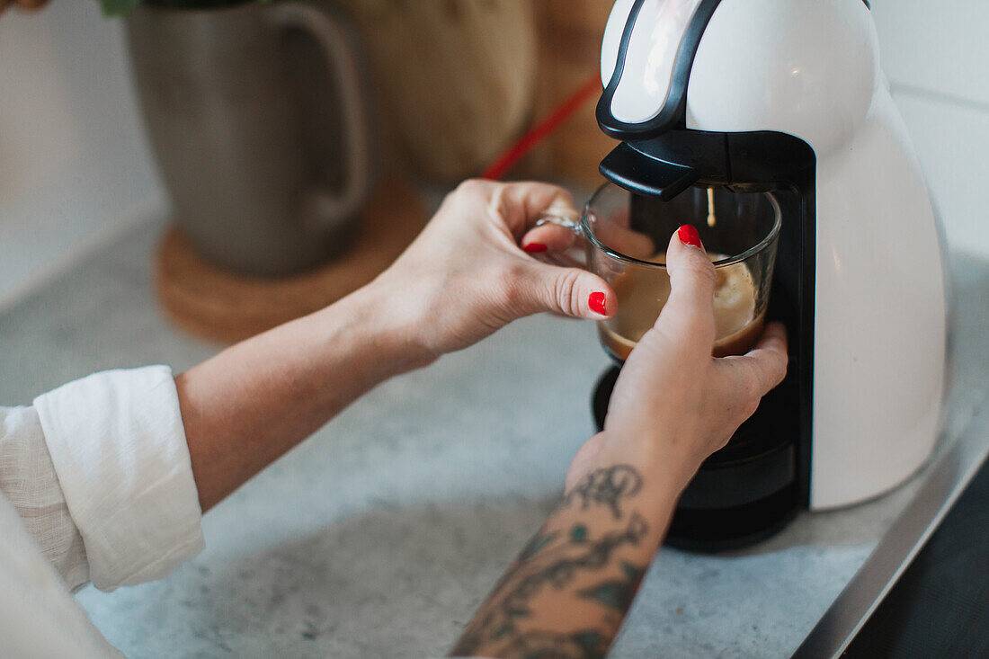 Young woman making coffee