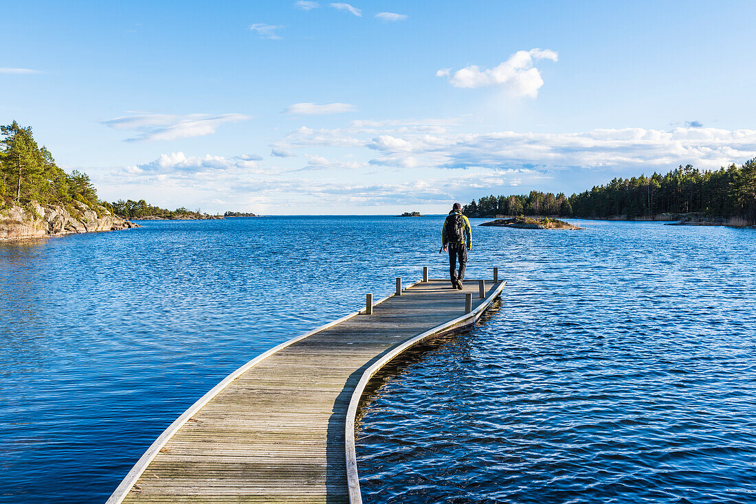 Hiker standing on pier