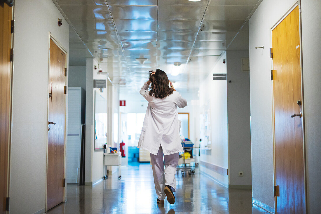 Doctor walking through hospital corridor