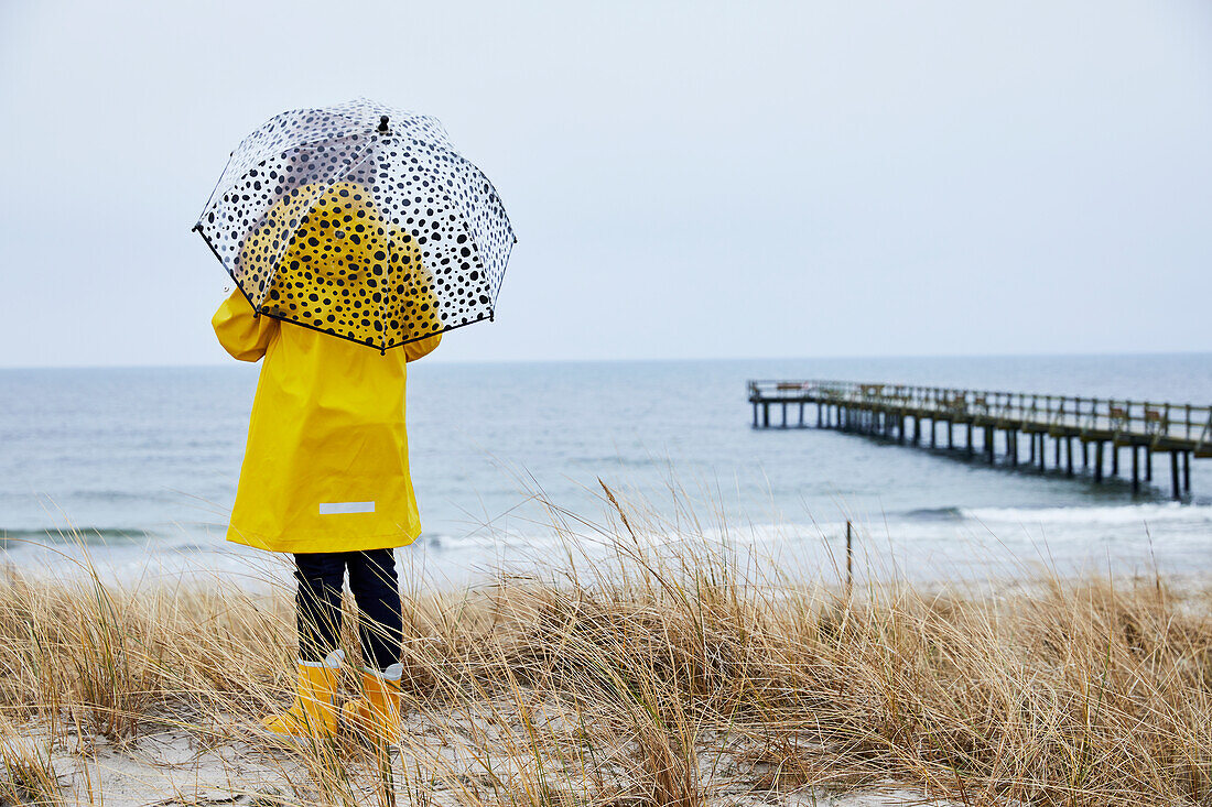 Girl with umbrella at sea