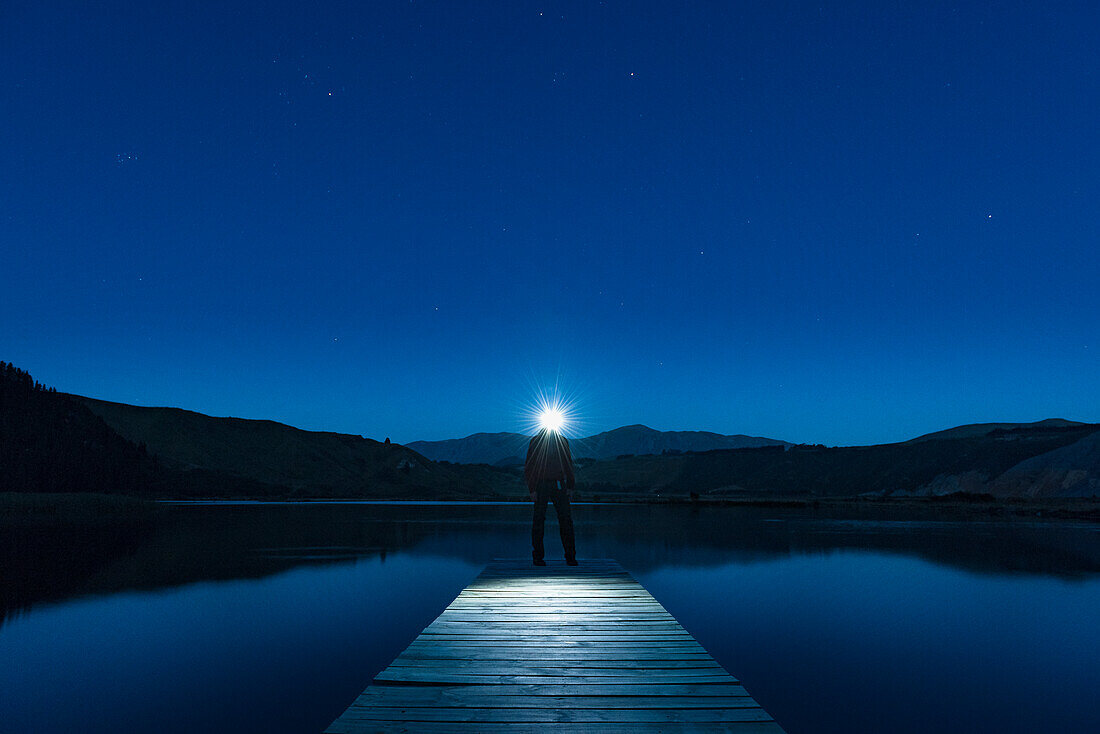 Person on jetty at night