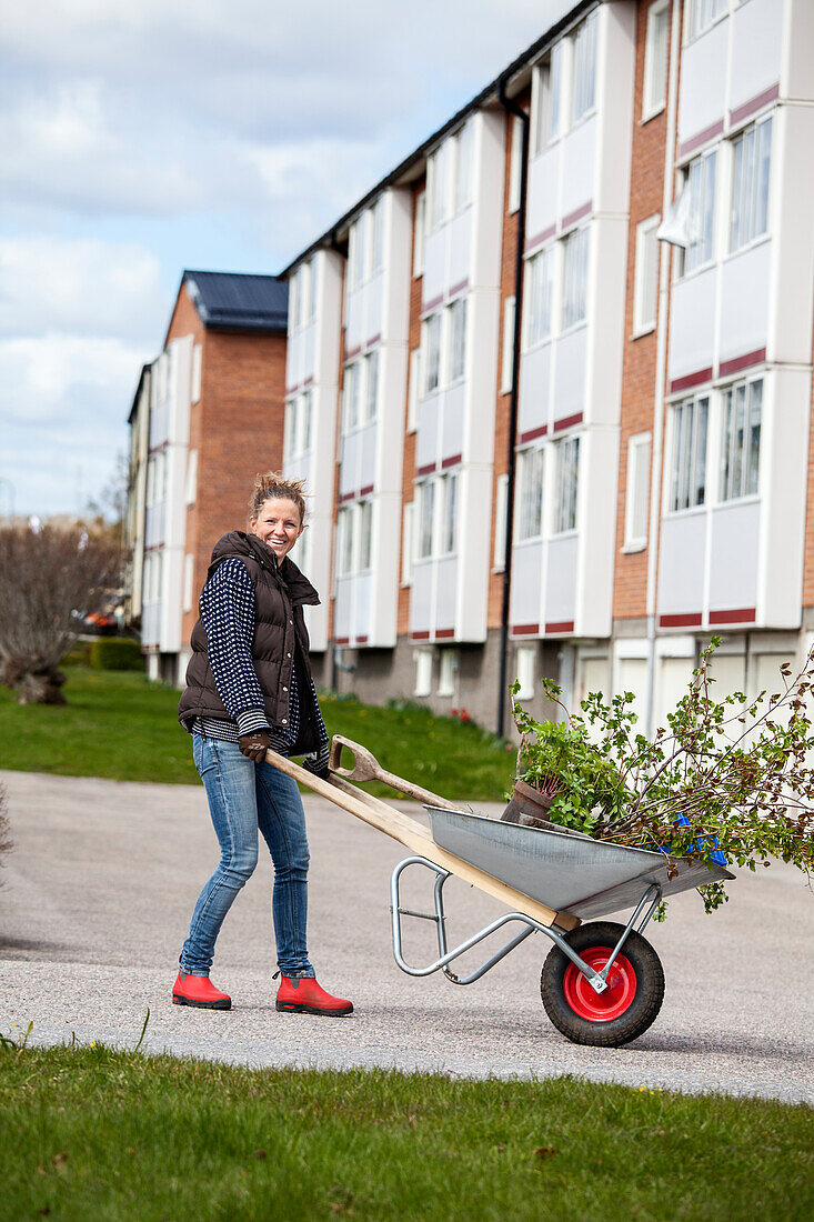 Woman pushing wheelbarrow