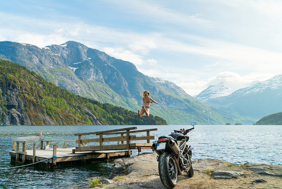 Woman jumping in lake