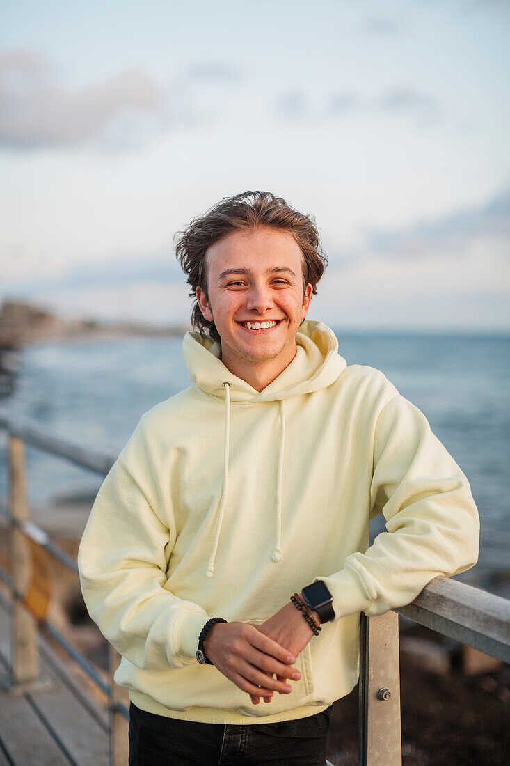 Young man enjoying sunset at seaside