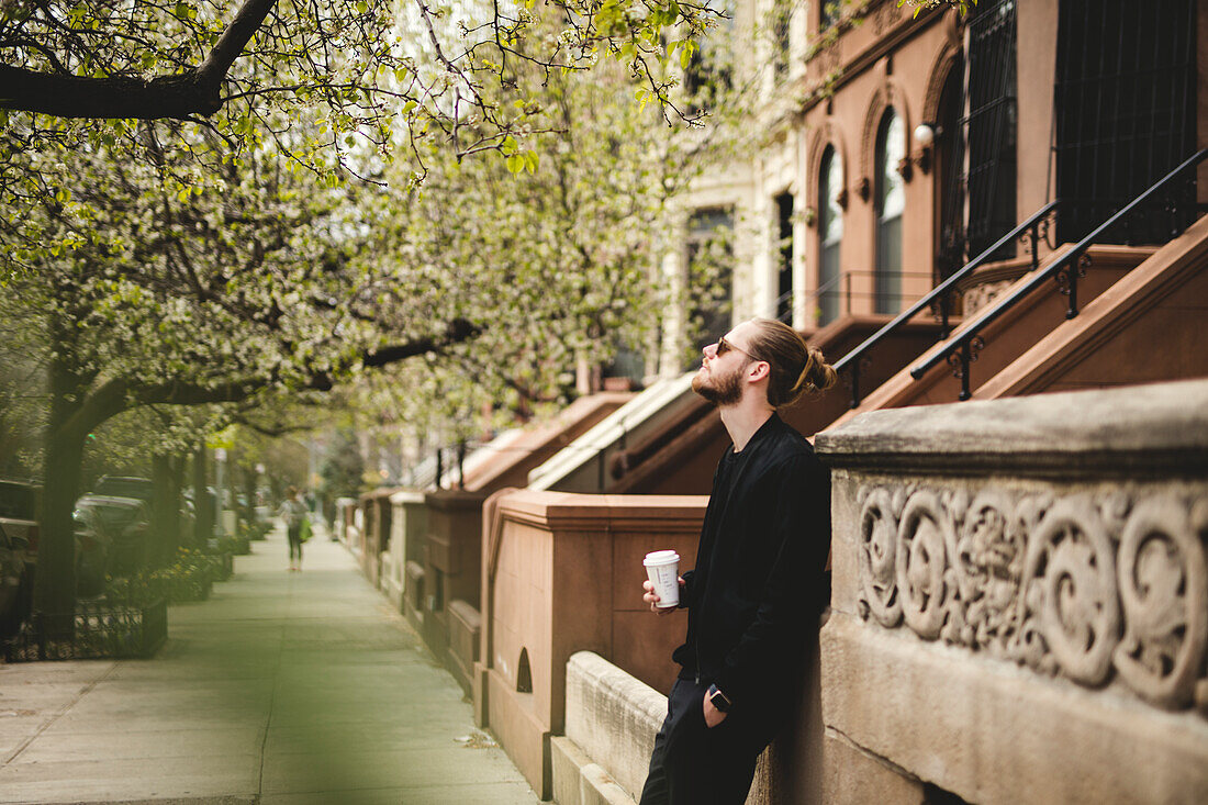 Man with take away coffee on street