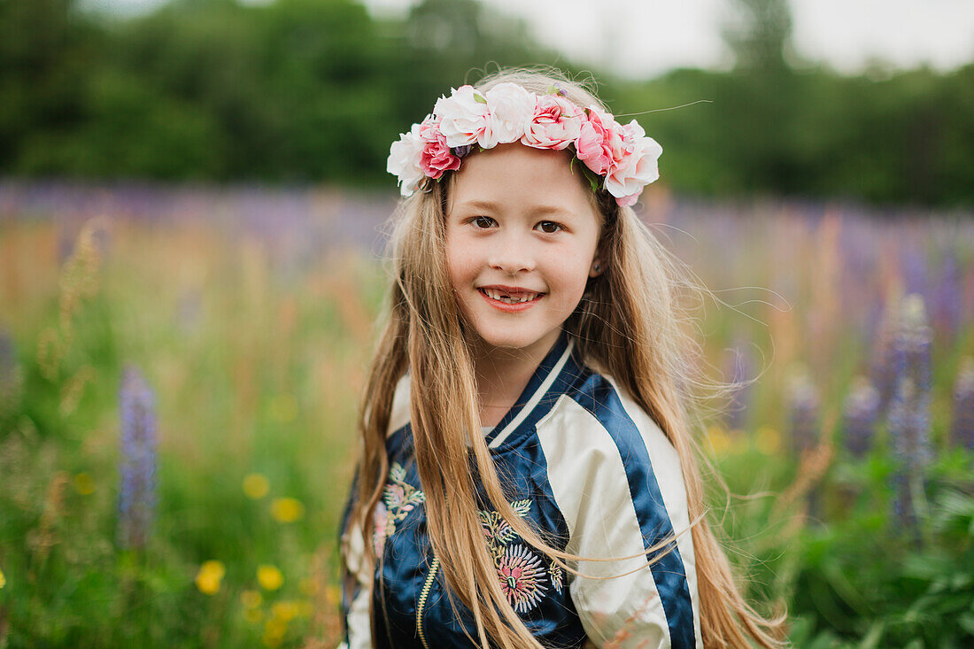 Porträt eines lächelnden Mädchens mit Blumenkranz
