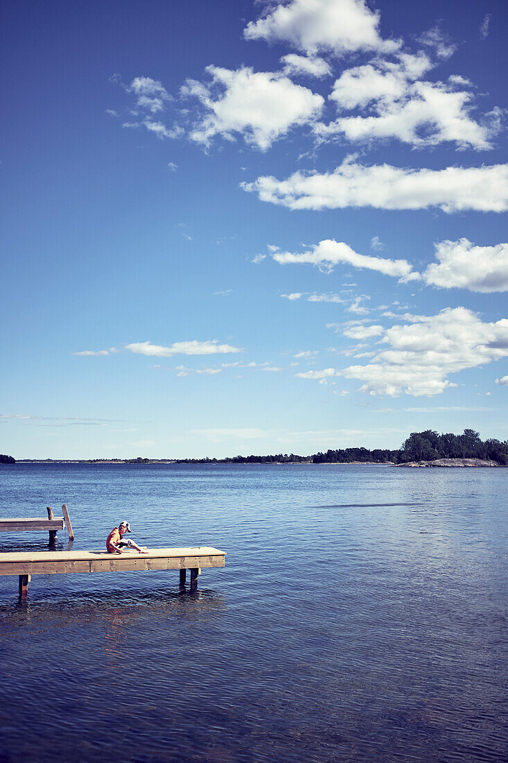 Boy relaxing on jetty