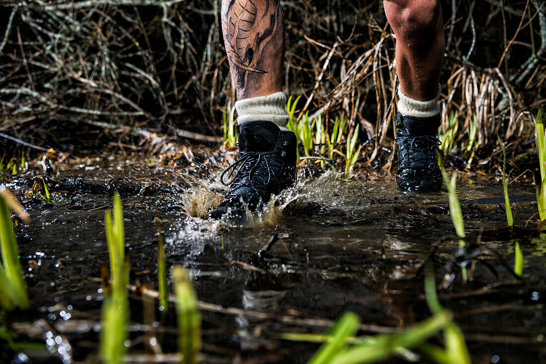 Man walking through water, low section