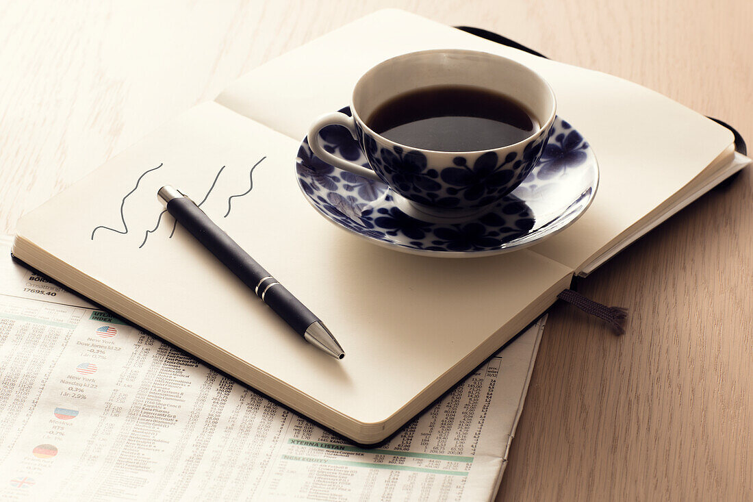 Coffee cup on notebook