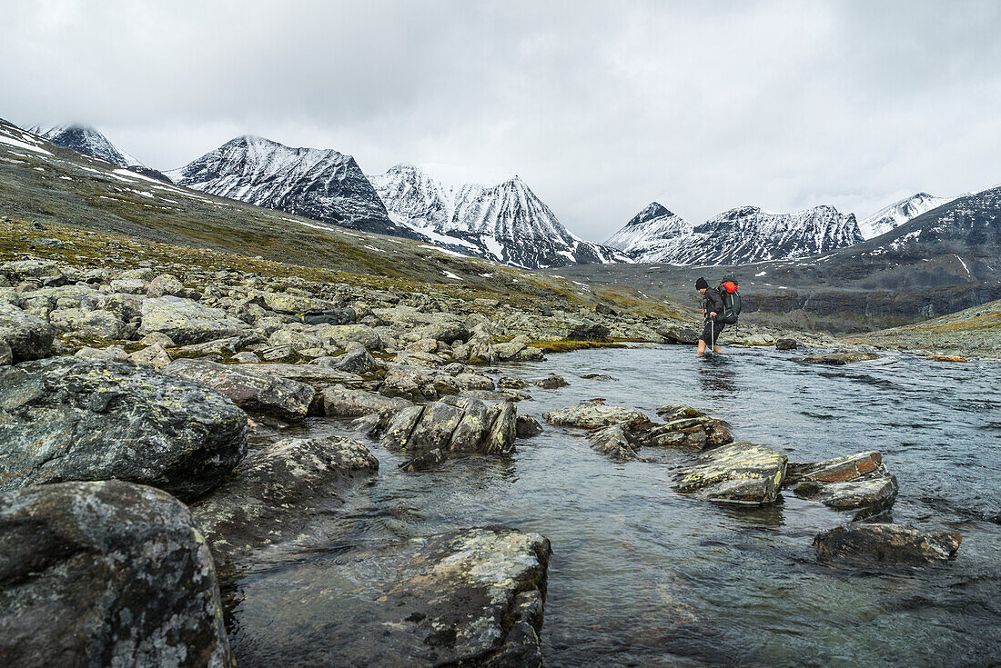 Hiker crossing river