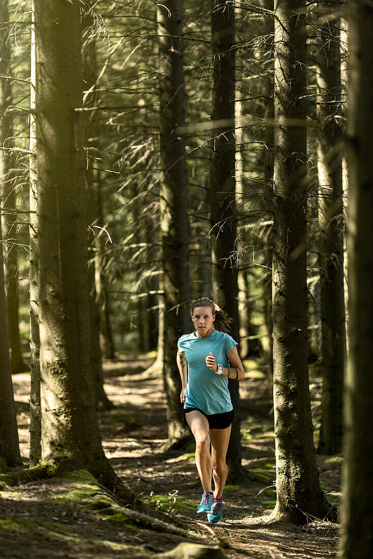 Woman running in forest