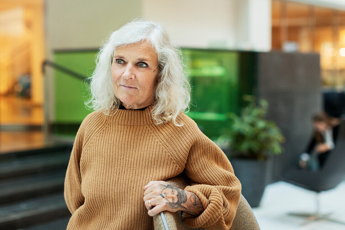 Tattooed woman in office