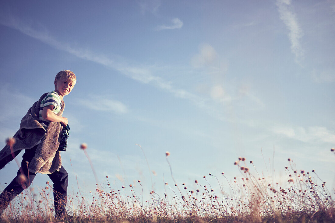 Boy walking in meadow