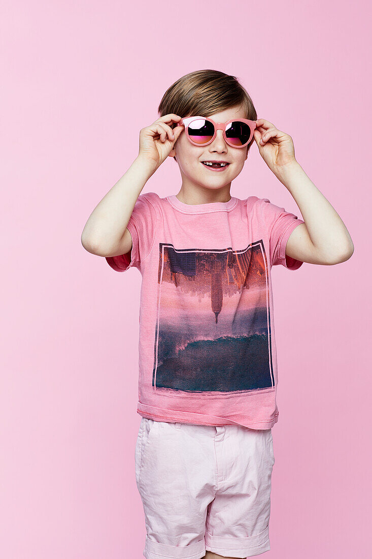 Smiling boy on pink background