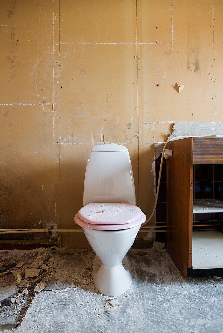 Toilet in dirty bathroom during renovation