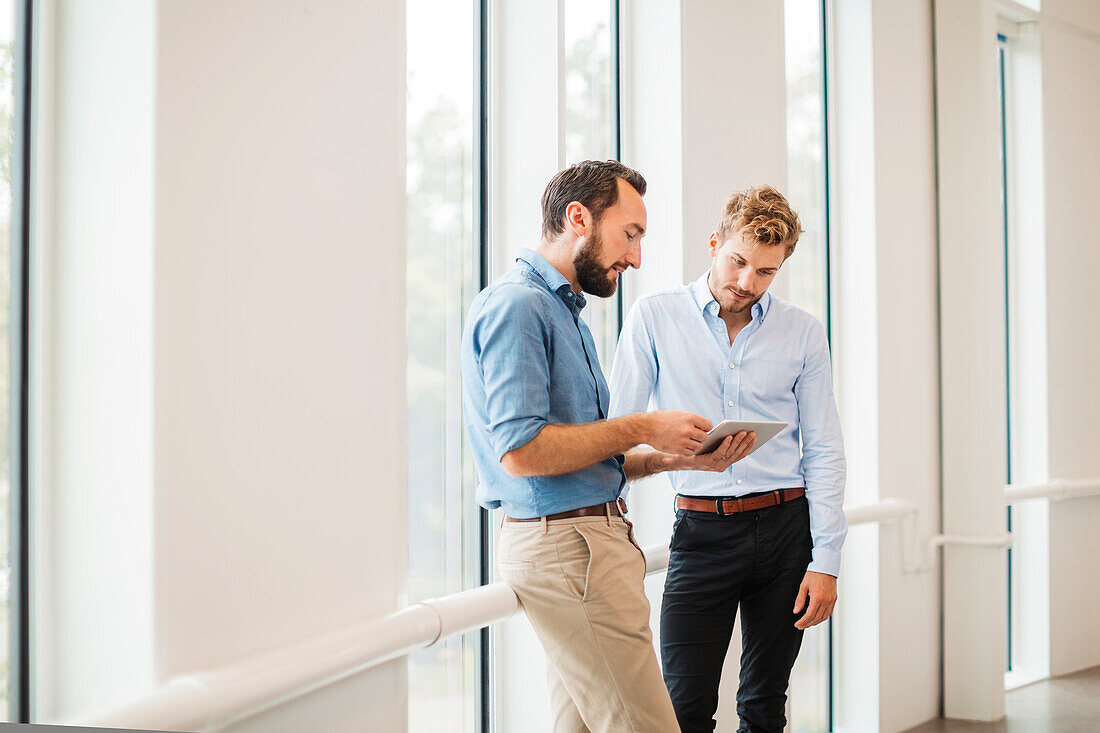 Two men talking in corridor