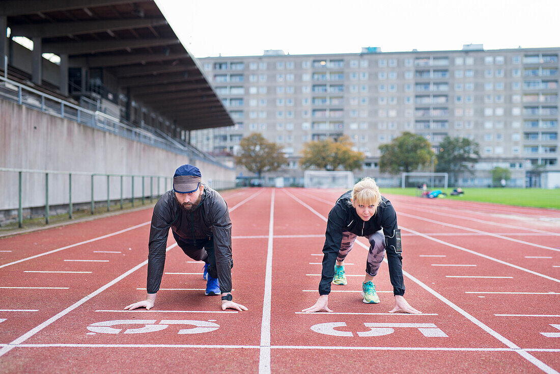 Man and woman on running track