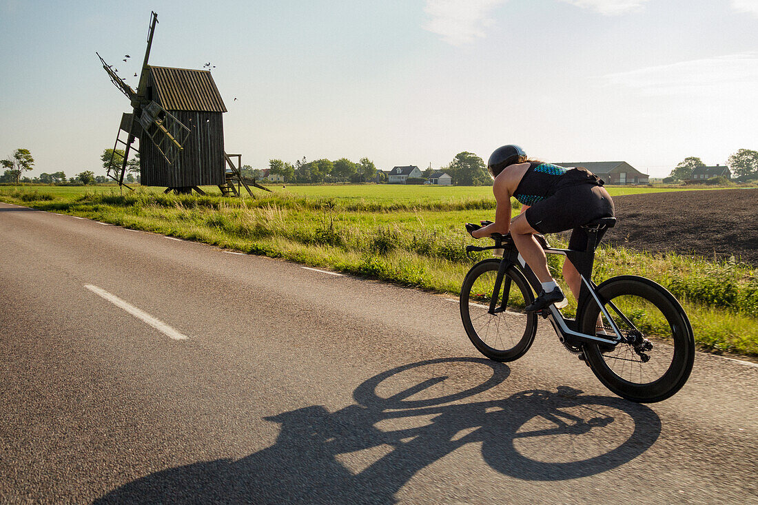 Woman cycling on country road