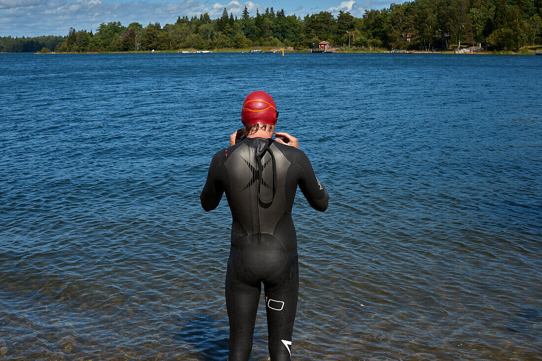Man standing in wetsuit in river