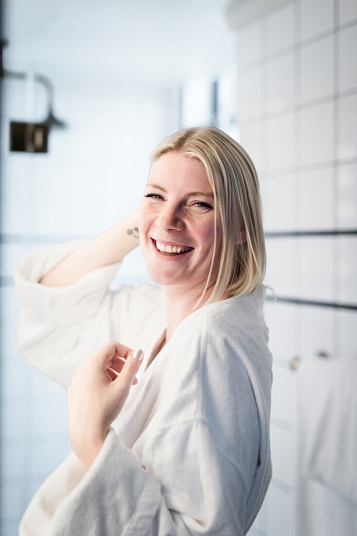 Happy blond woman in bathroom