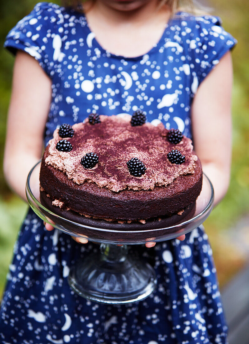 Girl holding chocolate cake