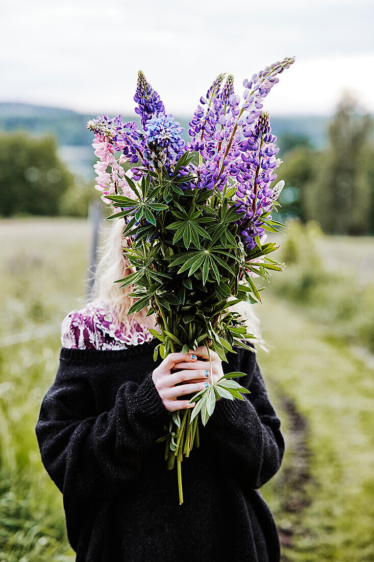 Girl with flowers in meadow