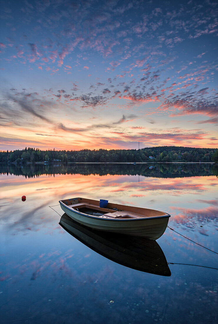 Rowing boat on lake at sunset