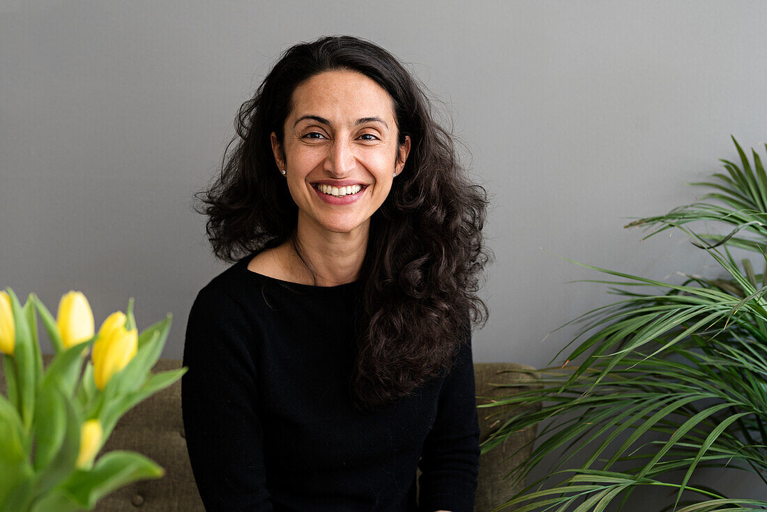 Smiling woman sitting on sofa