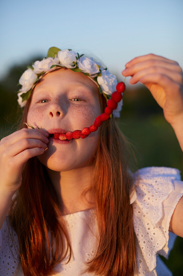 Girl eating wild strawberries