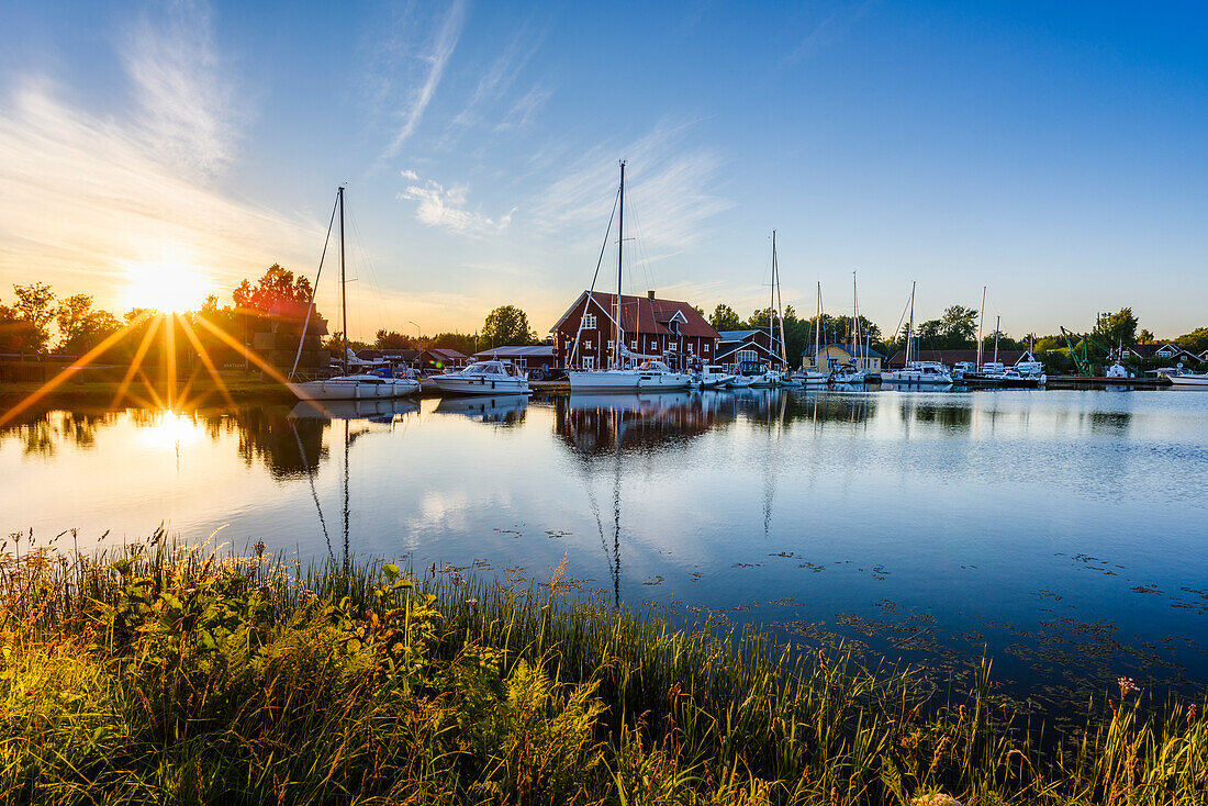 Moored sailing boats at sunset