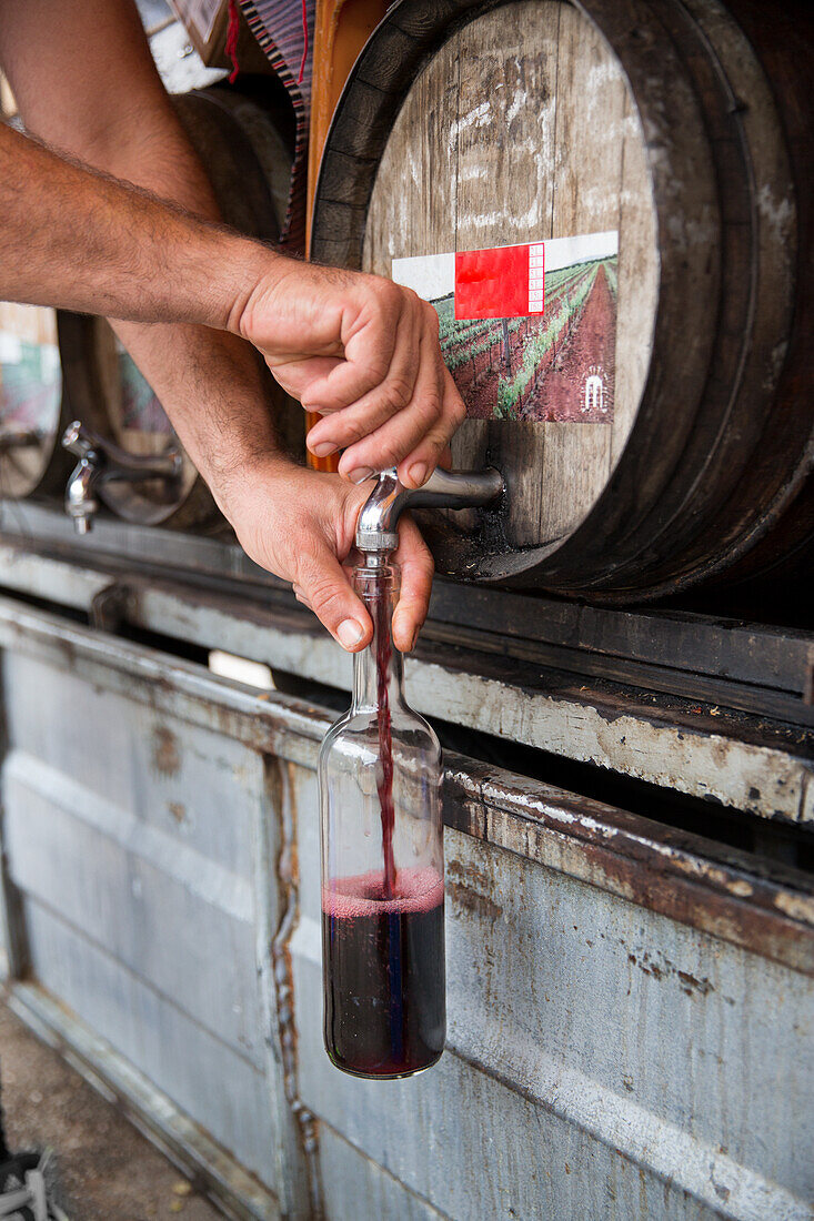 Pouring wine from barrel