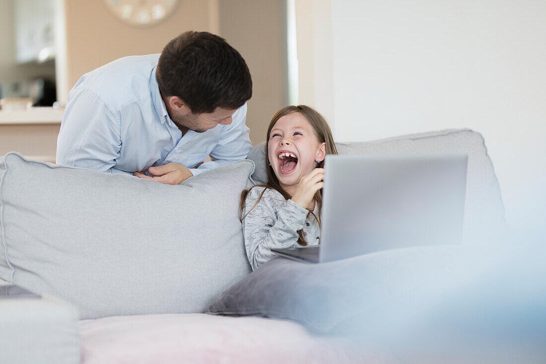 Father and daughter on sofa