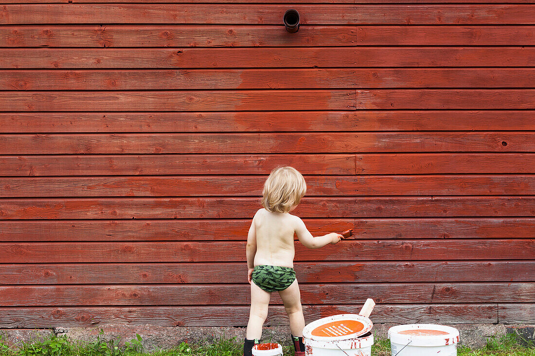 Boy painting house